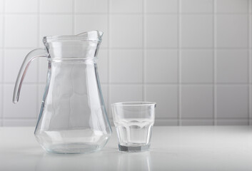 Empty jug and glass of milk