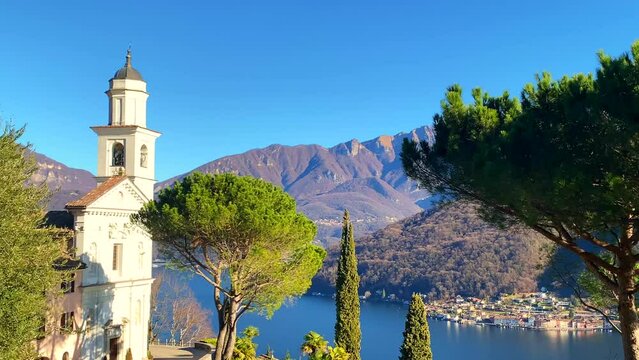 Mountain View and Church San Simone and Fedele with Tree on Lake Lugano in Vico Morcote in Ticino, Switzerland.