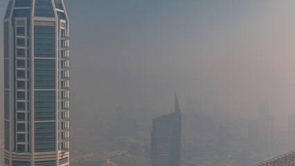 Naklejka premium Dubai Aerial view showing haze over al barsha heights and greens district area timelapse