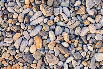 Colorful small pebbles or stone on sea pebble beach as background