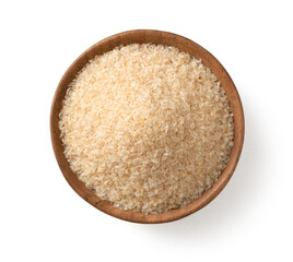 Psyllium husks in the wooden bowl, isolated on white background, top view.