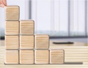 Hand puts wooden empty cubes for different icons