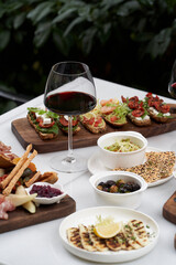 Italian antipasti wine snacks on table, outdoor party