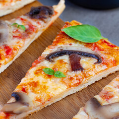 Piece of pizza with mushrooms close-up