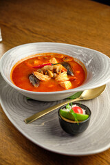 Mediterranean cuisine. Mussel soup with tomatoes and herbs