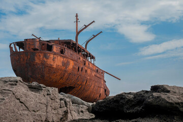 Plassey shipwreck on shore of Inisheer island. Aran islands, county Galway, Ireland. Rough stone...