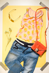 female summer image on a yellow background flat lay