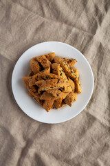 Homemade Italian Cantuccini with Chocolate on a White Plate, top view. Crispy Chocolate Cookies. Flat lay, overhead, from above.