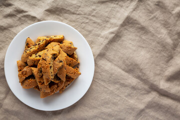 Homemade Italian Cantuccini with Chocolate on a White Plate, top view. Crispy Chocolate Cookies. Flat lay, overhead, from above. Space for text.