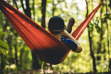 Relaxing in hammock in tropical forest