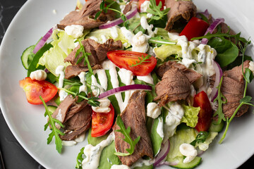Beef tongue salad with fresh vegetables. Serving food in a restaurant. Photo for the menu