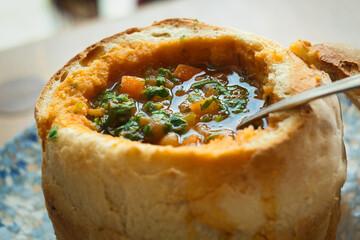 Bean and smoked pork soup in a bread bowl in Sibiu, Romania