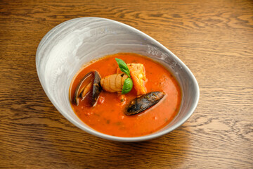 Mediterranean cuisine. Mussel soup with tomatoes and herbs