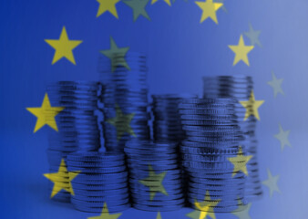 Double exposure of European Union flag and coins on table, closeup view
