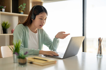 Online learning, portrait of happy asian female freelancer or smiling woman student using a laptop for a video call with a teacher, distance education concept