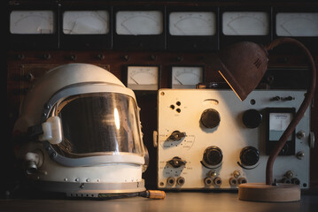 Concept of astronaut helmet on the table of the orbital station background.