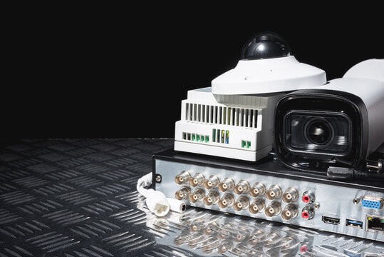 Modern white security cameras and video recorder close up. Video surveillance equipment background with copy space.