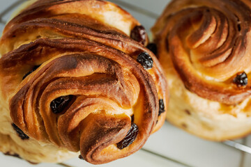 Modern pastry: layered buns with raisins. Shallow depth of field.