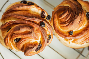 Modern pastry: layered buns with raisins. Shallow depth of field.