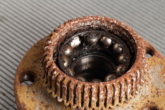 Old rusty wheel hub with a broken bearing. Bearing jamming. Automotive Part, close-up.