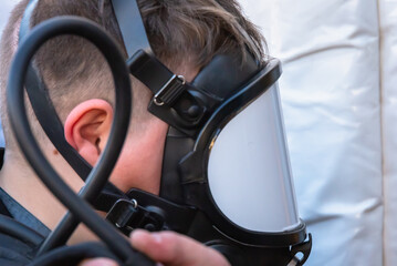 A boy in a mask against gas and smoke.