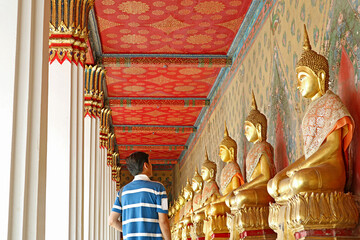 Visitor at the Cloister with Large Group of Seated Buddha Images in Wat Arun or The Temple of Dawn,...