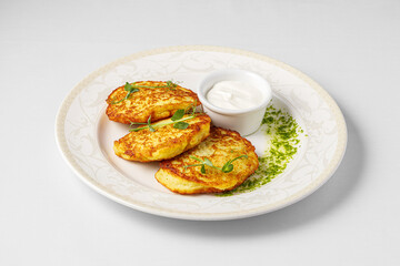 Potato fritters, latkes, draniki, hash browns. Vegetable pancakes on a plate. Close up Draniki,...