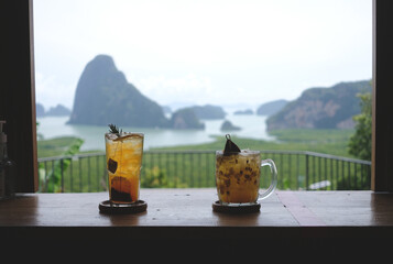 Two glass of tea and passion fruit juice with landscape scenery view