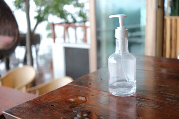 Bottle of hand gel on wooden table