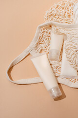 Fototapeta na wymiar Natural skincare beauty product in mesh bag on beige backdrop