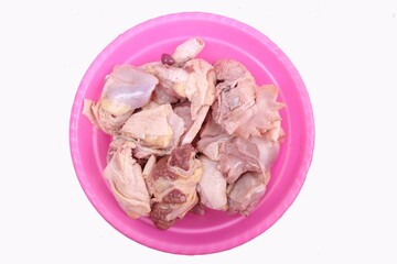 top view of pile of chicken pieces in pink bowl. clipping path
