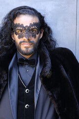 Mysterious elegant long haired man in masquerade