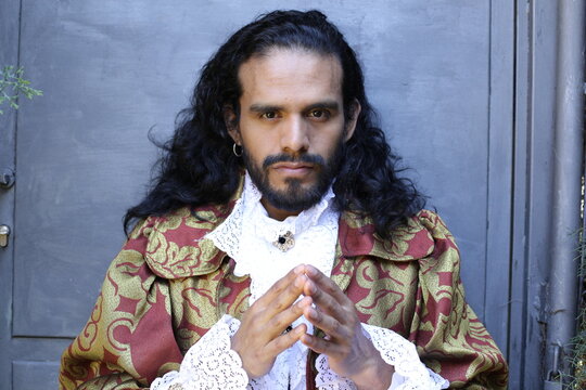 Long haired man wearing baroque fashion