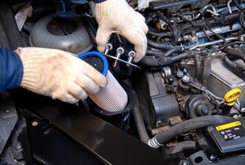 Replacing a new fuel filter on a modern car to clean the fuel from dirt. Close-up