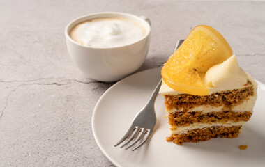 Vegan homemade carrot cake with orangewith cup of coffee on concrete background