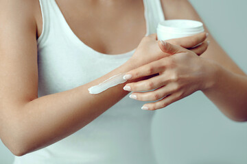 Beautiful woman hands with cream. Closeup woman applying protective cream on hands.