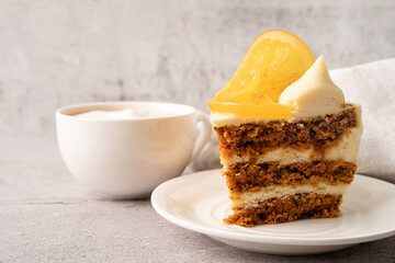 Vegan homemade carrot cake with orangewith cup of coffee on concrete background