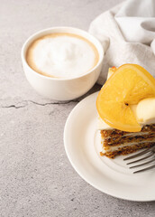 Vegan homemade carrot cake with orangewith cup of coffee on concrete background