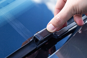 Replacing a car windshield wiper wiper with graphic coating wipers, close-up
