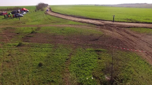 Low Flying Aerial Of Subaru Rally Car Drifting Around A Corner With Dust Flying