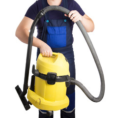 A man in overalls holds an industrial vacuum cleaner in his hands on a white background. The...