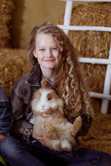 a girl on a farm playing with rabbits and chickens