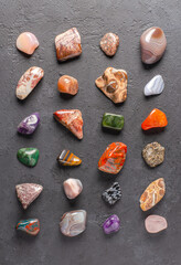 Mineral stones on a black concrete background. The concept of using minerals in astrology and alternative or complementary medicine.