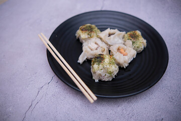 dim sum food served on a black plate