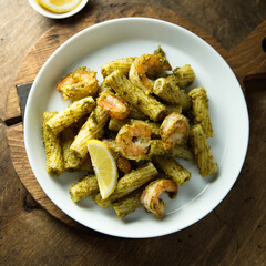 Pasta with pesto sauce and shrimps