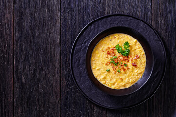 corn chowder in bowl on table, top view