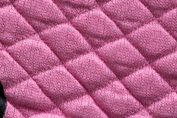 Fototapeta na wymiar Pink new fabric in diamond pattern, background, macro. Stylish, design