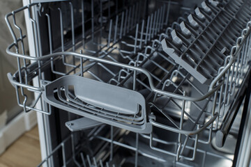 open dishwasher. racks and dishwasher containers.
