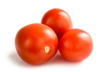 Three red tomatoes isolated on a white background