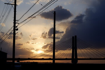 Naklejka na ściany i meble sunset over the harbor with bridge silhouette